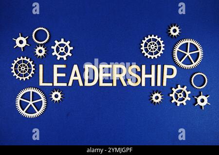 Leadership alphabet letters with gears element on navy blue background Stock Photo
