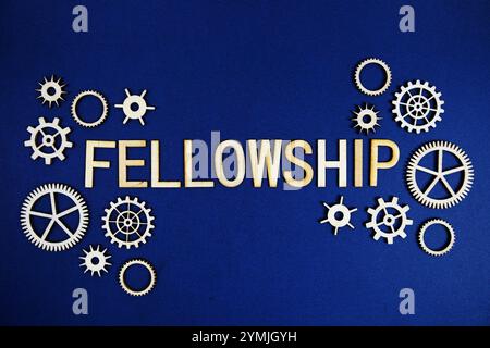 Fellowship alphabet letters with gears element on navy blue background Stock Photo