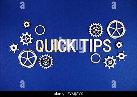 Quick Tips alphabet letters with gears element on navy blue background Stock Photo