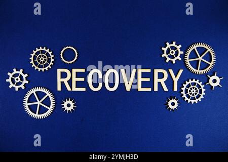 Recovery alphabet letters with gears element on navy blue background Stock Photo