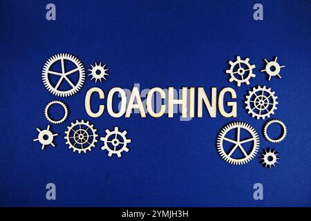 Coaching alphabet letters with gears element on navy blue background Stock Photo