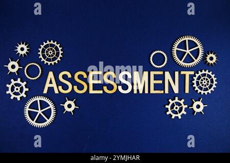 Assessment alphabet letters with gears element on navy blue background Stock Photo