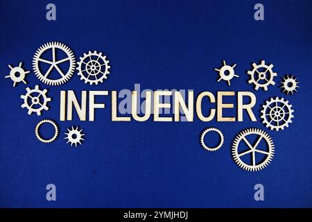 Influencer alphabet letters with gears element on navy blue background Stock Photo