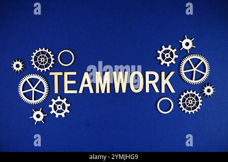 Teamwork alphabet letters with gears element on navy blue background Stock Photo