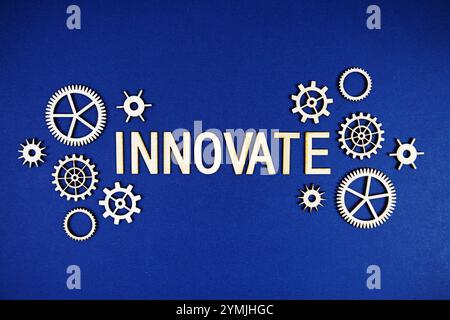 Innovate alphabet letters with gears element on navy blue background Stock Photo