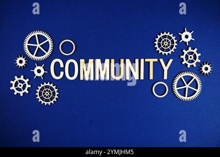 Community alphabet letters with gears element on navy blue background Stock Photo