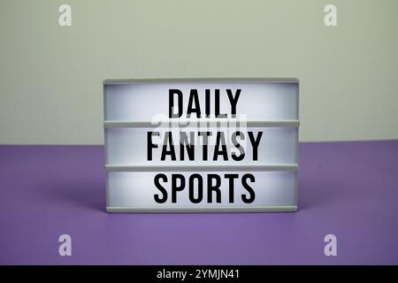 Daily Fantasy Sports text on LED lightbox on purple background Stock Photo