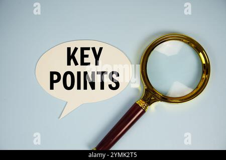 Key Points text on speech bubble with magnifying glass top view on blue background Stock Photo