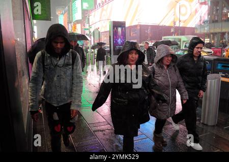 New York, United States. 21st Nov, 2024. People walk in a rainstorm in Times Square, Manhattan, New York City. (Photo by Jimin Kim/SOPA Images/Sipa USA) Credit: Sipa USA/Alamy Live News Stock Photo