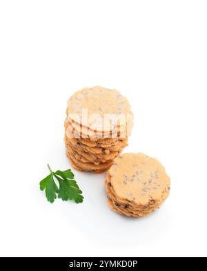 Stack  of thin round crispbreads with herbs isolated on white Stock Photo