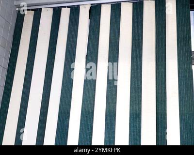 a window curtain, curtain is a piece of cloth or other material intended to block or obscure light, air drafts, Curtains are hung on the inside of a b Stock Photo