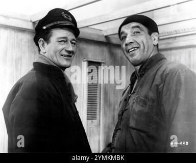 JOHN WAYNE and MIKE MAZURKI in BLOOD ALLEY 1955 director WILLIAM A. WELLMAN novel / screenplay Albert Sidney Fleischman music Roy Webb Batjac Productions / Warner Bros. Stock Photo