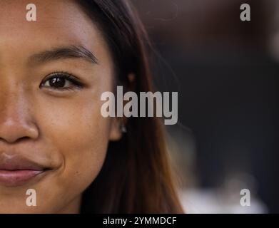 Smiling warmly, asian female teenager in close-up portrait, copy space, at home. happiness, cheerful, youth, emotional, face Stock Photo