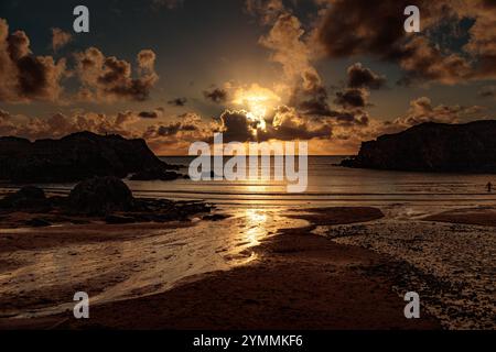Sunbeams at sunset over Porth Dafach on the Isle of Anglesey, North Wales Stock Photo