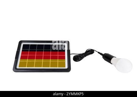 Portable solar panel in the shape of the flag of Germany connected to a light bulb isolated on white background (close-up) Stock Photo