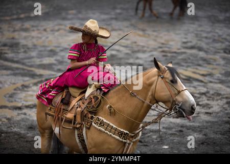 A young amazona girl rides her horse before participating in an exhibition in Mexico City Stock Photo