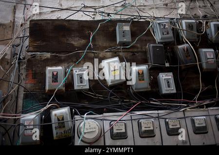 Electricity meters hang on a wall in an apartment building in Mexico City Stock Photo