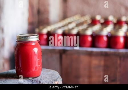 traditional tomato sauce conserved in  glass jar on a wooden base Stock Photo
