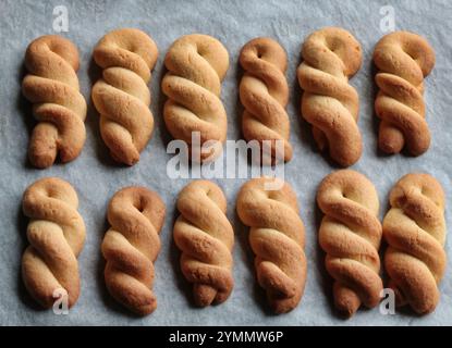 group of pastry cookies in braid shape on greaseproof paper Stock Photo