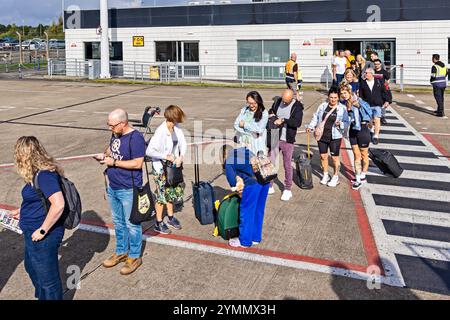 Passengers on runway waiting to board KLM Eastern flight from Teesside International Airport, Darlington, County Durham, England, UK Stock Photo