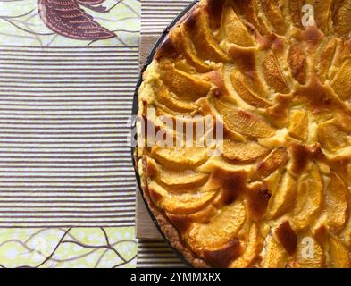 fresh shortbread cake decorated with slices of peach on lemon cream Stock Photo