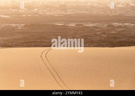 Car tire marks in a Sand dune in Sandwich Harbour, Namib Naukluft Natural Park, abstract landscape in Namibia, Africa Stock Photo