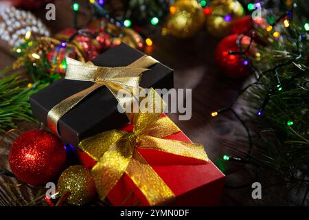 Christmas banner with many gift boxes tied with red and gold ribbons and Christmas tree decorations on wooden background. Merry Christmas Stock Photo