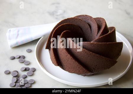 delicious  dark chocolate cake on white plate, grey marble background Stock Photo