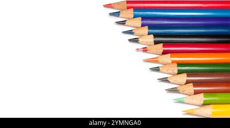Numerous colored pencils in various shades are laid out in a creative arrangement on a white background, ideal for artistic endeavors and creative pro Stock Photo
