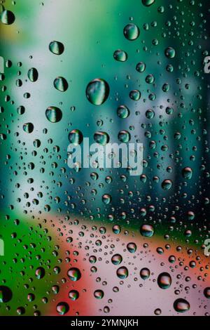 Forest view through a window on a rainy day, Rain drops on window. Stock Photo