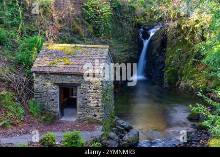 A river flowing over Rydal Falls in the Lake District National Park, Cumbria, UK. This building fates from the 17th Century and is known as The Grot Stock Photo