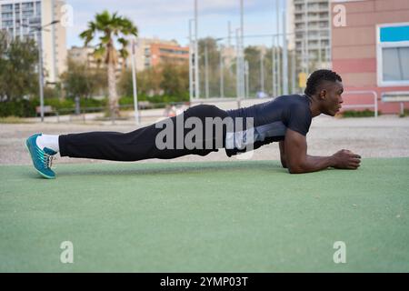 Young black man doing calisthenics plank in a park Stock Photo