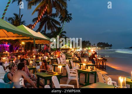 Restaurants on beach at dusk, Mirissa, South Coast, Sri Lanka Stock Photo