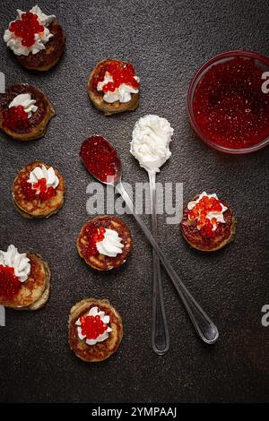 Demidoff pancakes, mini pancakes, with sour cream and red caviar, homemade, no people Stock Photo