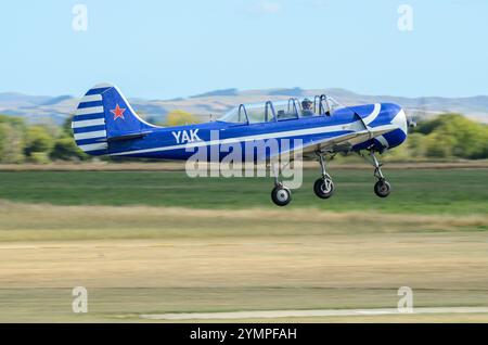 Yakovlev Yak-52 plane ZK-YAK taking off at Wings over Wairarapa airshow at Hood Aerodrome, Masterton, New Zealand Stock Photo