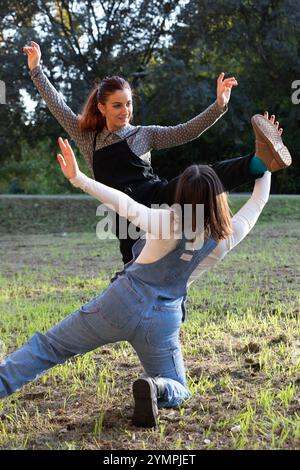 Two dancers are rehearsing a modern dance choreography in a park, showcasing their flexibility and artistic expression Stock Photo