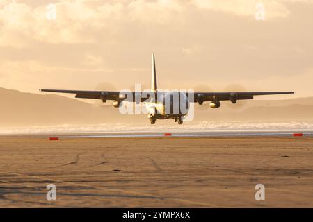 Royal Australian Air Force RAAF landing on Pembrey Sands with a C130 Hercules in South Wales managed by the RAF Tactical Air Traffic Controllers Stock Photo