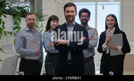 Portrait man confident CEO leader chief boss crossed arms posing in corporate office company leadership with professional multiracial businessmen and Stock Photo