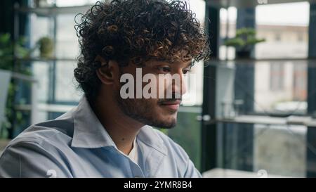 Business portrait of Arabian Indian Hispanic businessman happy smiling gen z guy remote job computer work at office male student ethnic man employer Stock Photo