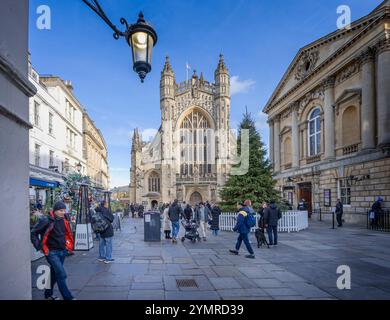 Bath Abbey and Abbey Churchyard bathed in sunset light with Christmeas tree and decorations in Bath, UK on 22 November 2024 Stock Photo