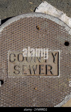 Vertical image County Sewer cast iron road manhole cover Los Angeles, California, USA. Stock Photo