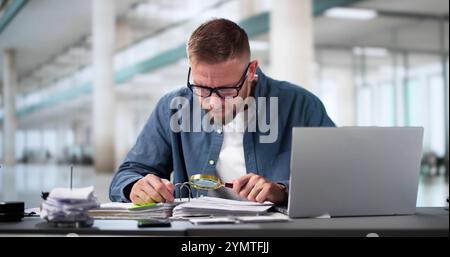 Auditor Using Magnifying Glass For Audit And Fraud Investigation Stock Photo