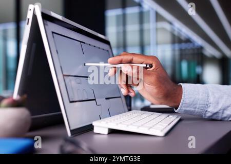Analyzing House Floor Plan On Digital Tablet: African-American Architect Renovating Hybrid Property For Real Estate Business With Designer. Stock Photo