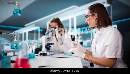 Medical Lab Scientist Woman Doing Research In Laboratory Using Microscope Stock Photo
