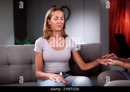 Hypnotherapy Psychotherapy Treatment. Woman Hypnotized By Hypnotist Stock Photo