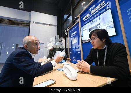 A participant from Hong Kong (left) learned about AI equipment of traditional Chinese medical science, Nov.21, 2024. Wuzhen,China.21th November 2024. The opening ceremony of the 2024 World Internet Conference Wuzhen Summit was held in Wuzhen, Zhejiang province, on Nov.20, 2024. Visitors attended the opening ceremony with enthusiasm, and those who made great contributions to certain technological fields were honored at the World Internet Conference Distinguished Contribution Award ceremony. The Light of Internet Expo opened on Nov 19 with the exhibition focusing on artificial intelligence. Peop Stock Photo