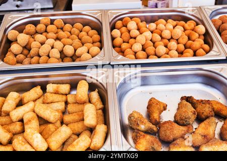 Fair stand with typical Italian street food with arancini, potato croquettes, supplì and fried chicken Stock Photo