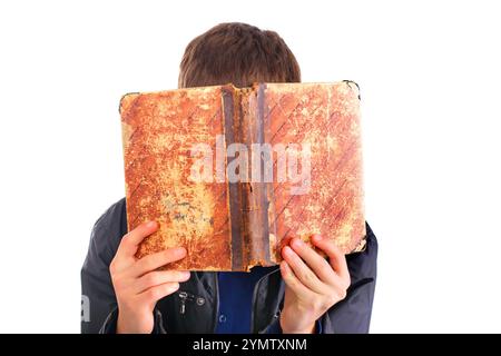 The person hides the face behind the old book Stock Photo