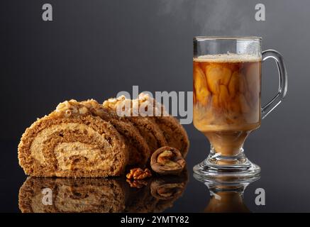 Dessert with walnuts and coffee latte on a black reflective background. Cake with brown sugar, walnuts, and cream. Copy space. Stock Photo