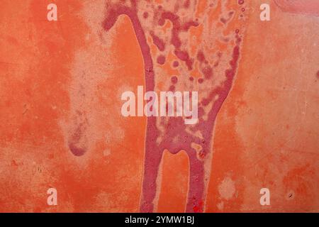old orange red paint cracked peeling, abstract background texture pattern wallpaper, macro closeup close detail, vintage aged faded Stock Photo